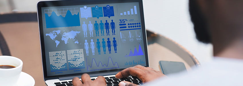 a person on their computer reviewing different data analytics charts.